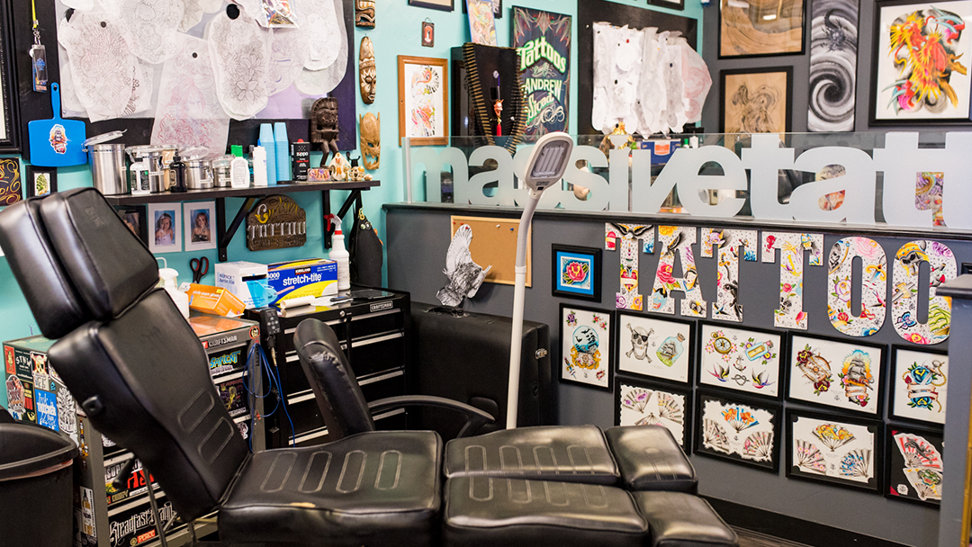 Close-up of tattoo station with flash art displayed on wall